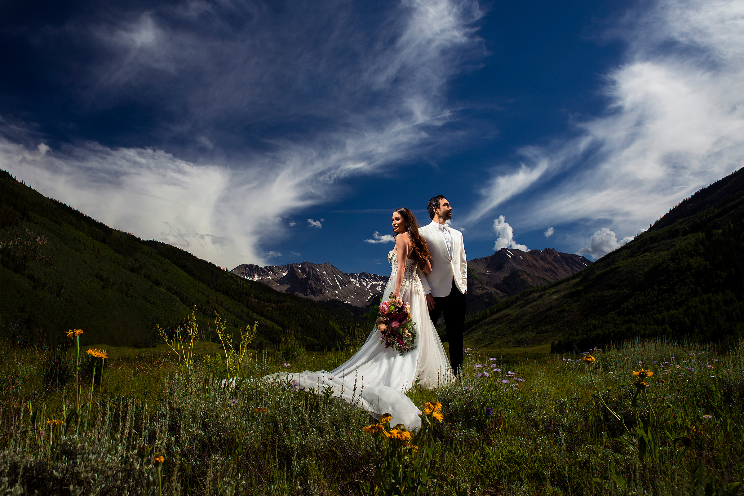 1-bride-and-groom-in-a-meadow-against-mountains-photo-by-j-la-plante-photo